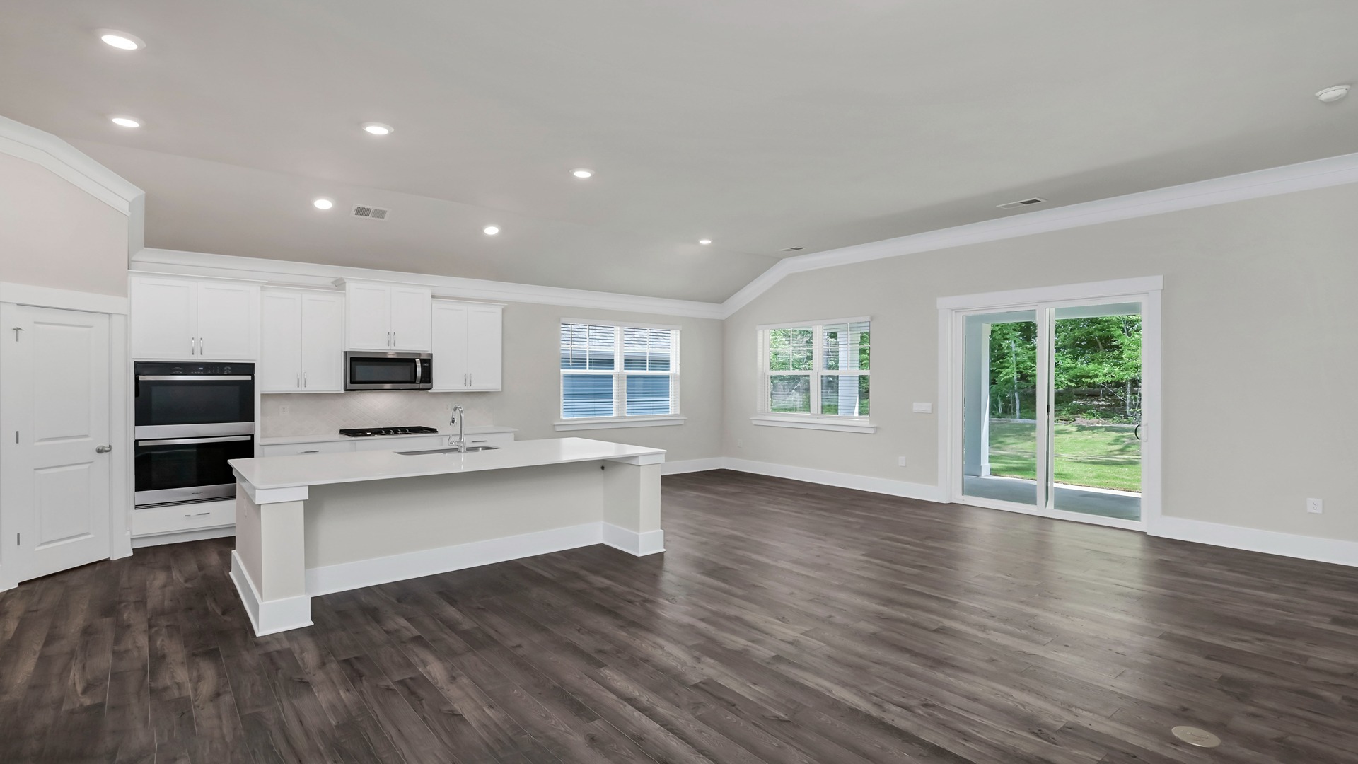 Open concept dining and kitchen areas with Revwood flooring