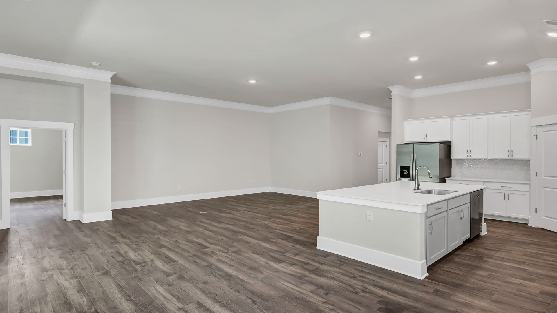 Living area and kitchen with access to primary bedroom