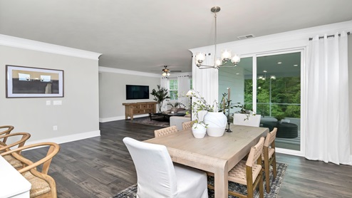 Access to the back patio from the dining area through glass sliding doors.
