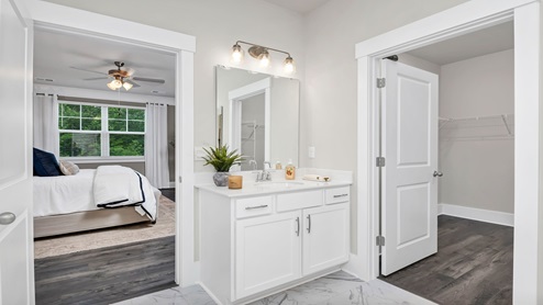 The primary bathroom is spacious with a standup shower and a separate water closet.