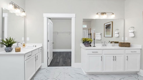 Primary bathroom with two separate vanities.