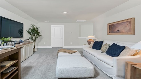 Upstairs functional loft space staged as a secondary living room and craft room.