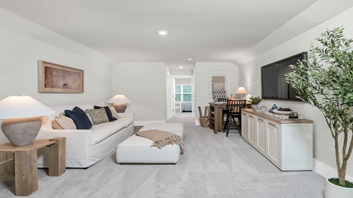 Upstairs functional loft space staged as a secondary living room and craft room.