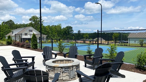 Firepit and seating by the pickleball court.