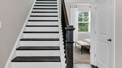 Oak tread stairs leading to upstairs space.