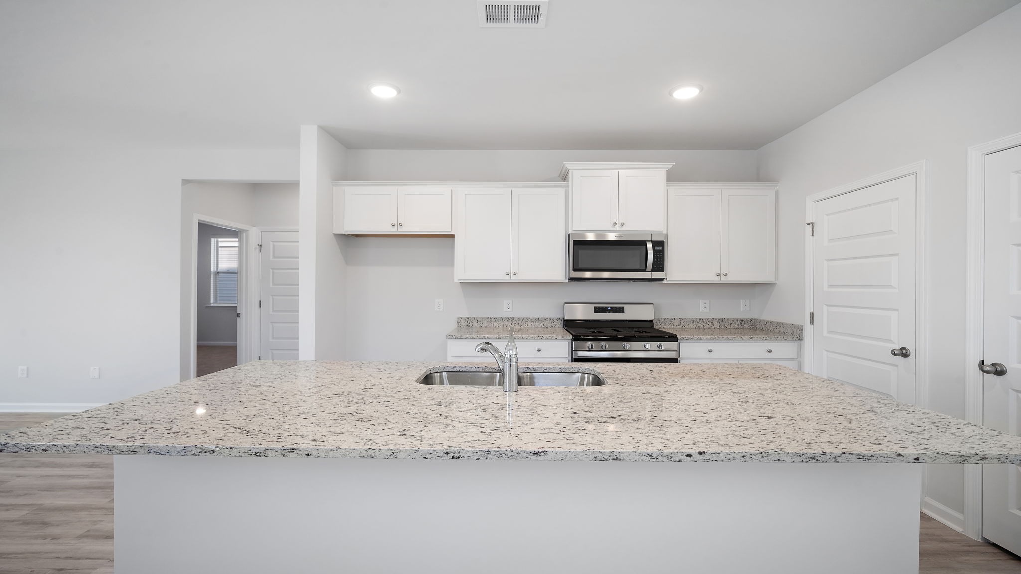 Downing kitchen with white cabinetry and granite countertops