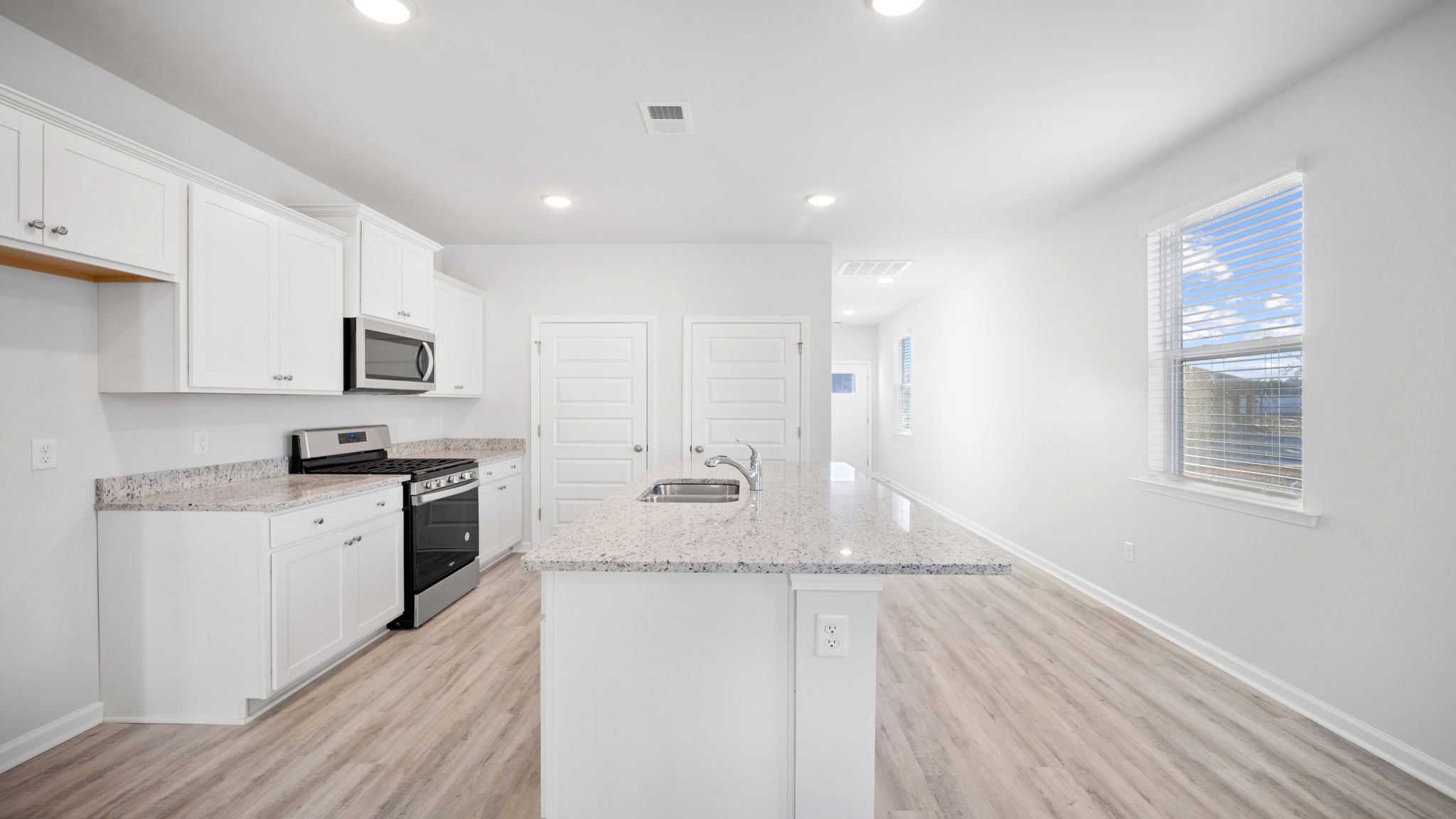 Floating kitchen island with barstool seating room in the Downing in Grand Oaks