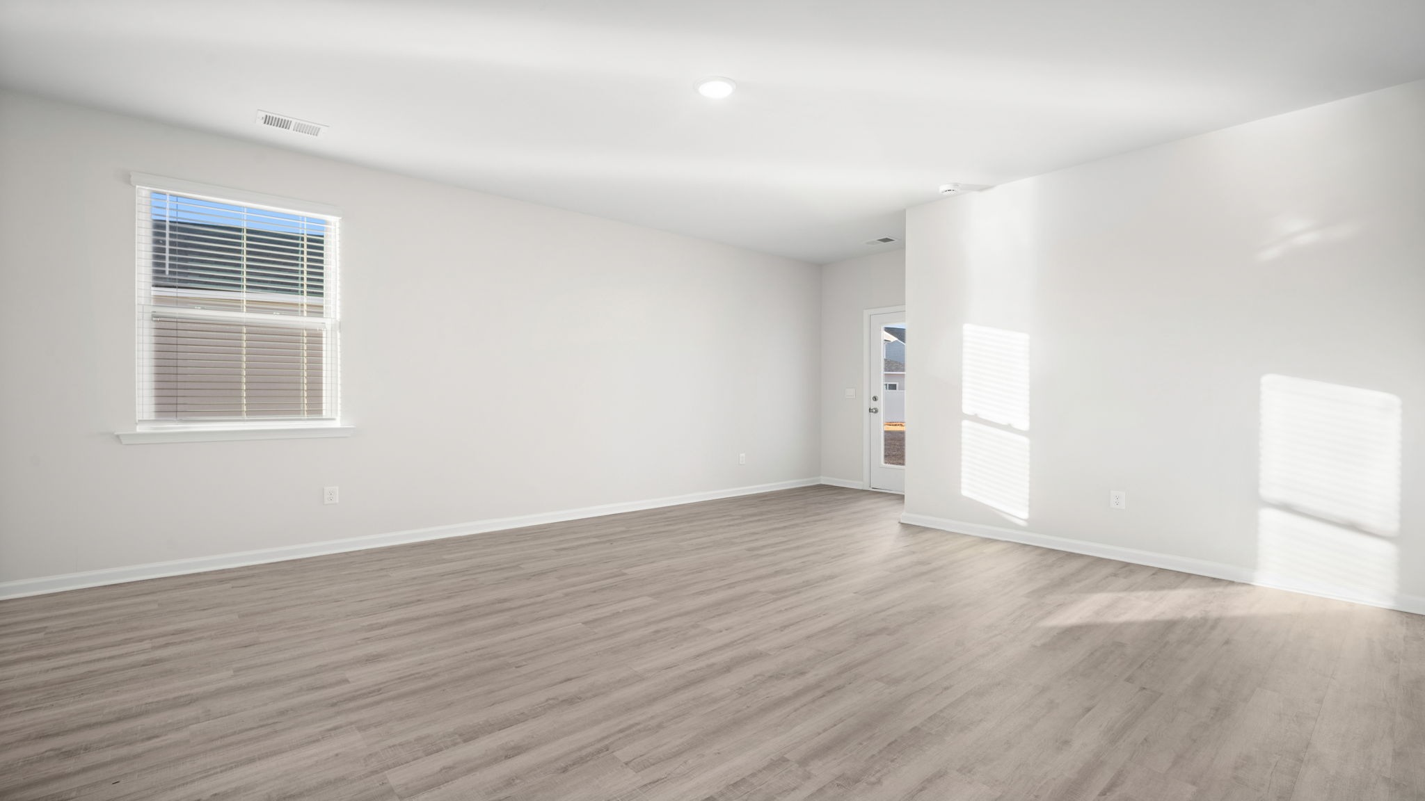 Unfurnished living area with vinyl flooring