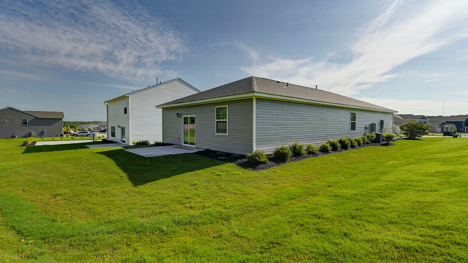Back exterior of a Cameron Model home featuring a rear patio