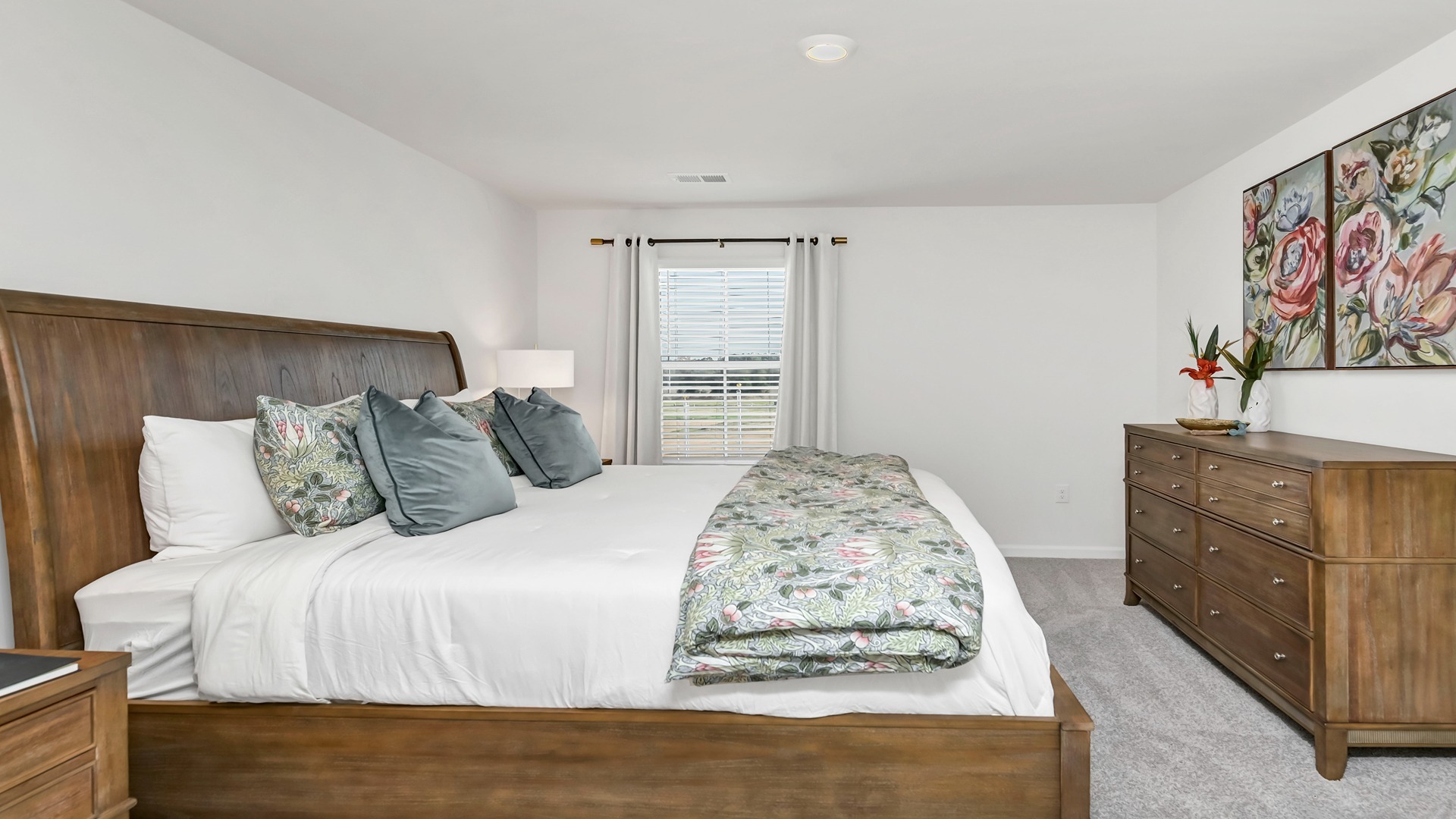 Primary bedroom with several windows and carpet flooring
