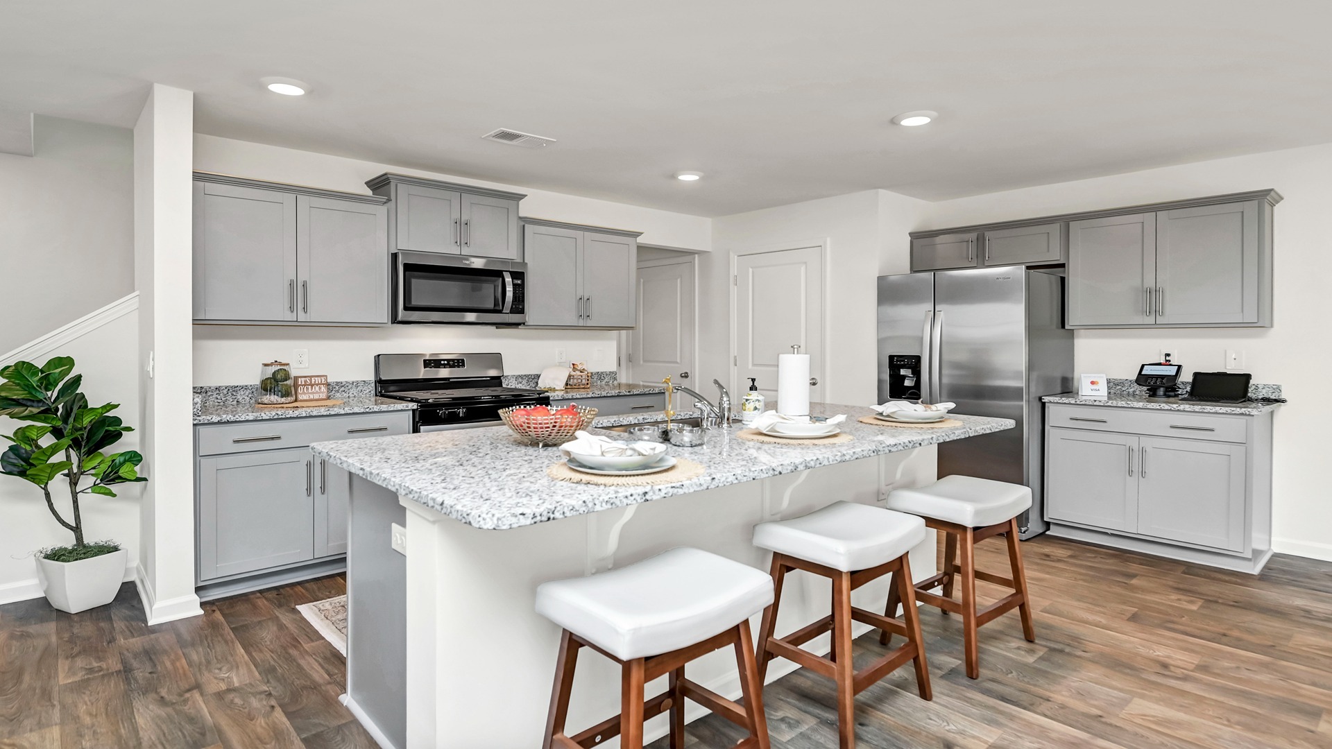Aisle kitchen with gray cabinetry and a floating kitchen island