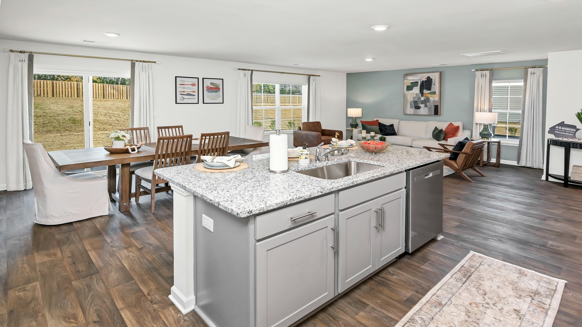 Floating kitchen island overlooks open dining and living areas of the Aisle floorplan