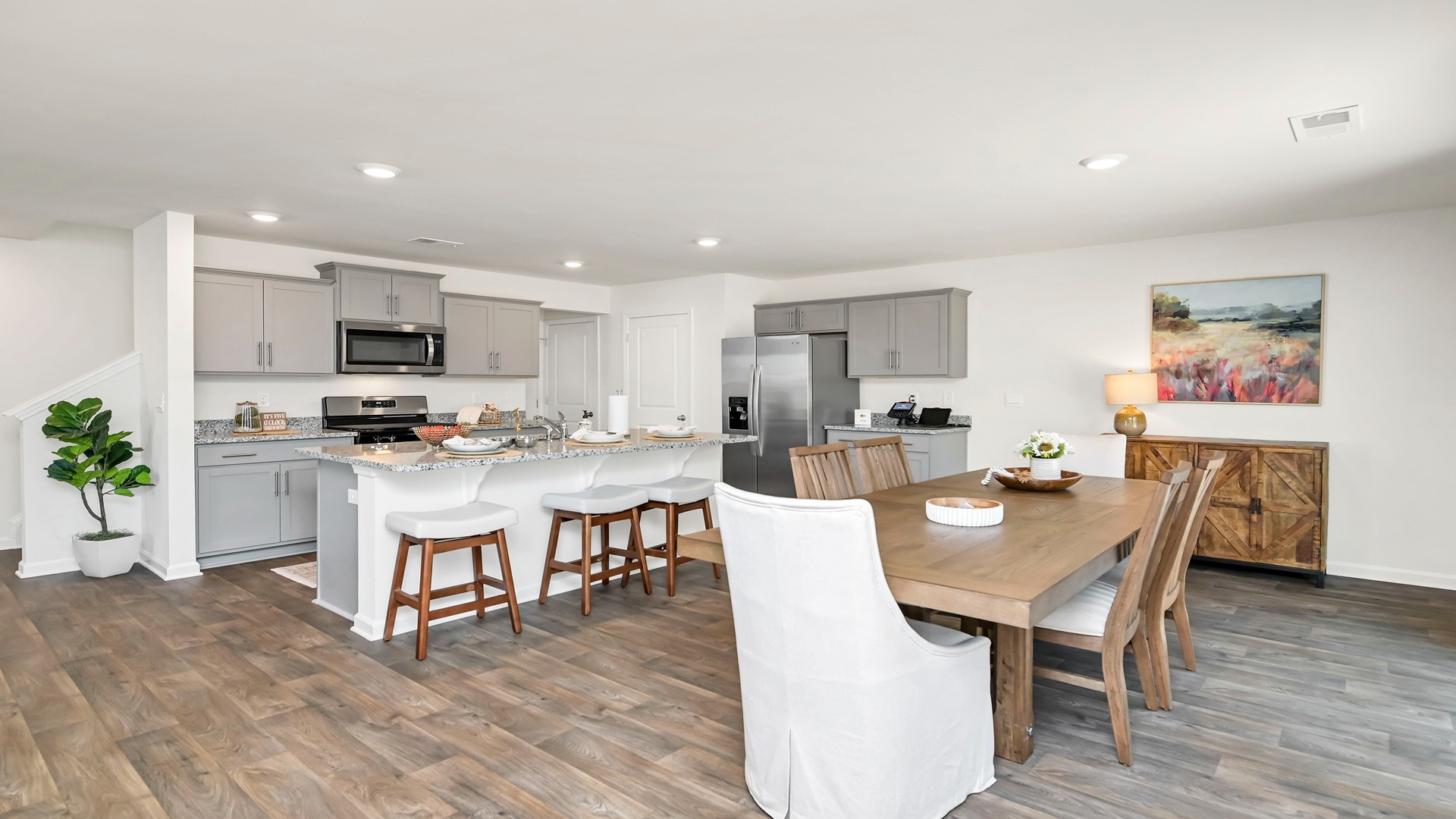 Open concept kitchen and dining areas in new construction home for sale in Grand Oaks
