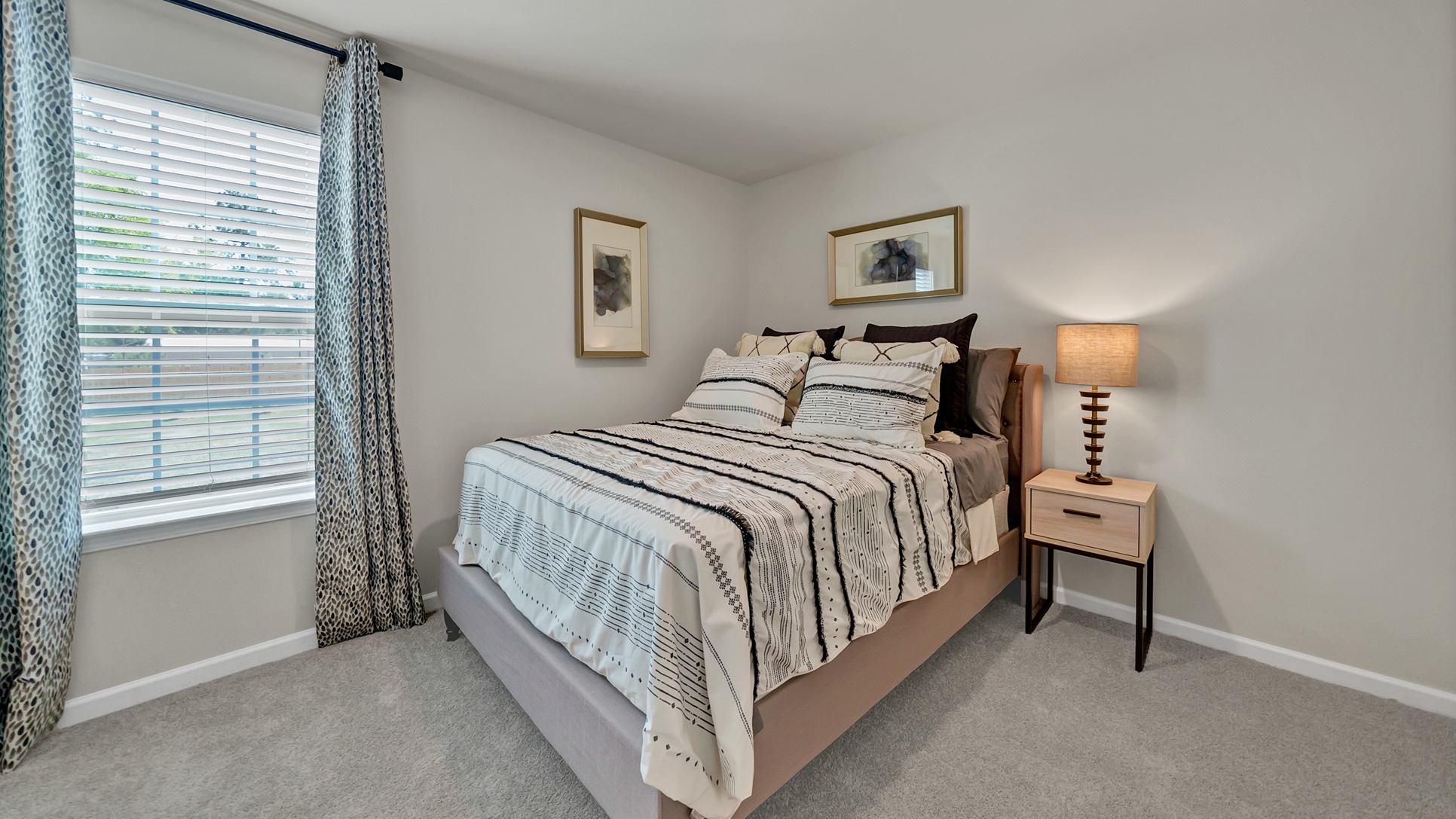 Downstairs bedroom with carpet flooring and a large window