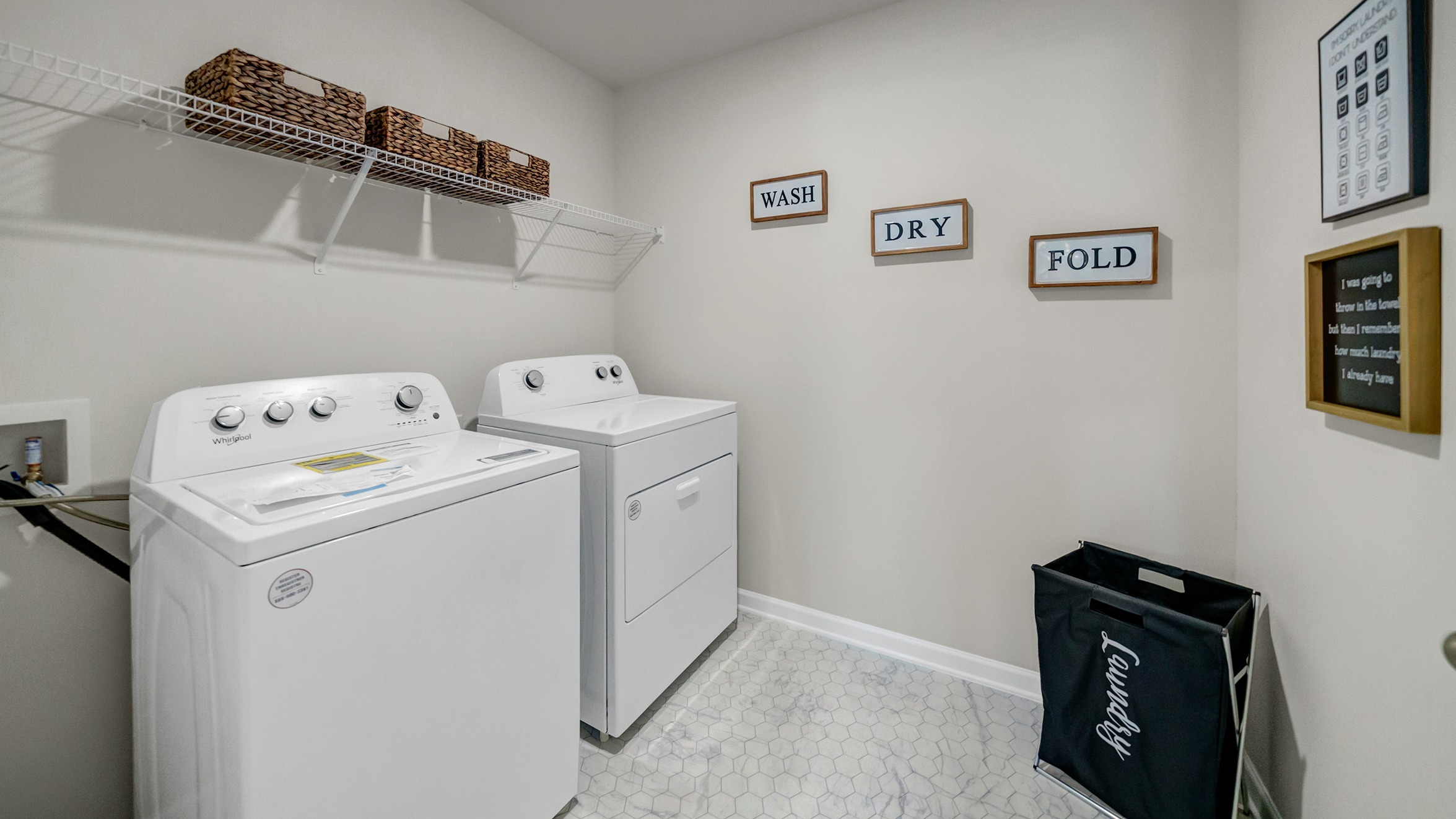 Upstairs laundry room with shelving above