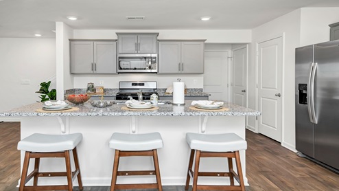 Room for barstool seating at the kitchen breakfast bar.