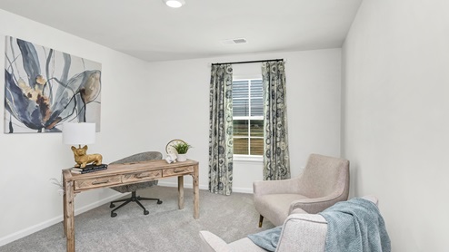 Bedroom 3 is located upstairs and is staged as an office space.