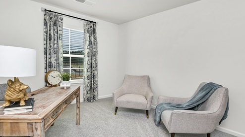 Bedroom 3 is located upstairs and is staged as an office space.