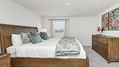 The primary bedroom has several windows for natural light.