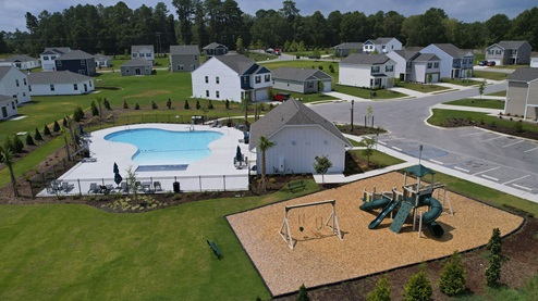 Drone amenity photo of the pool, cabana, and playground