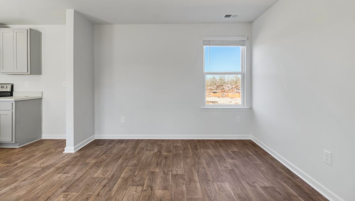 Open living area with a window for light and vinyl floors