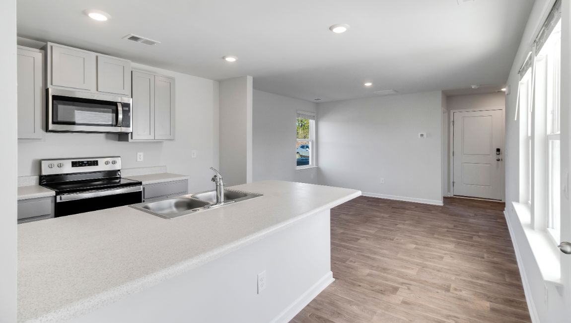 View from kitchen bar of kitchen and living spaces