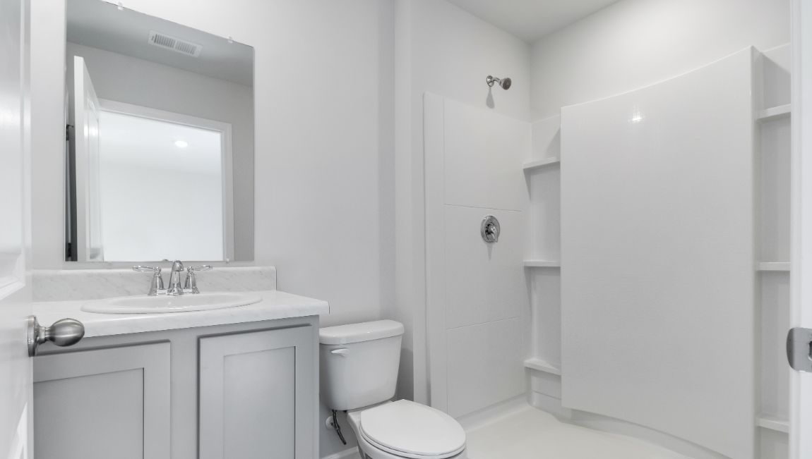 En-suite primary bathroom with single-sink vanity and standup shower