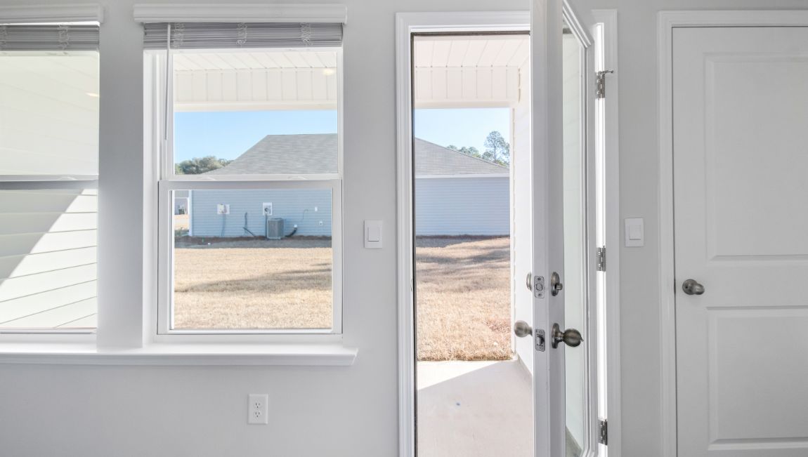 Side door from kitchen area leads onto a covered patio