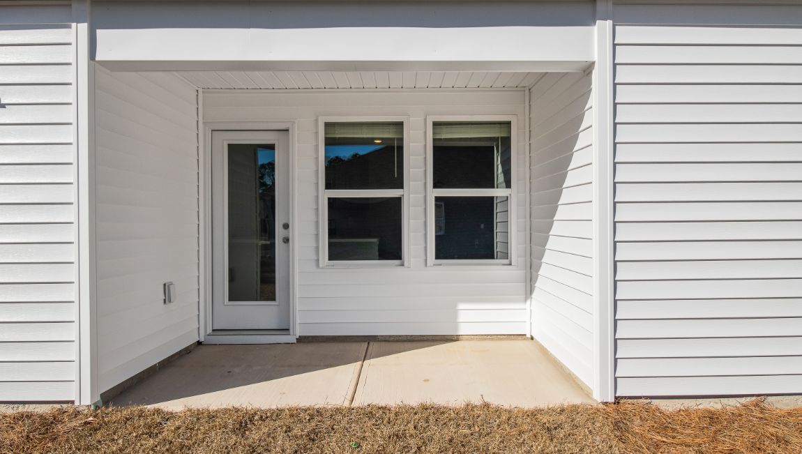 Side covered, paved patio in the Hannah