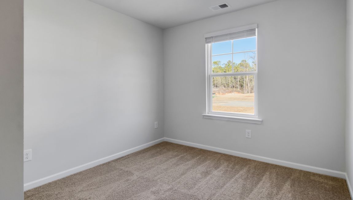 Bedroom 2 with a front facing window and carpet floors