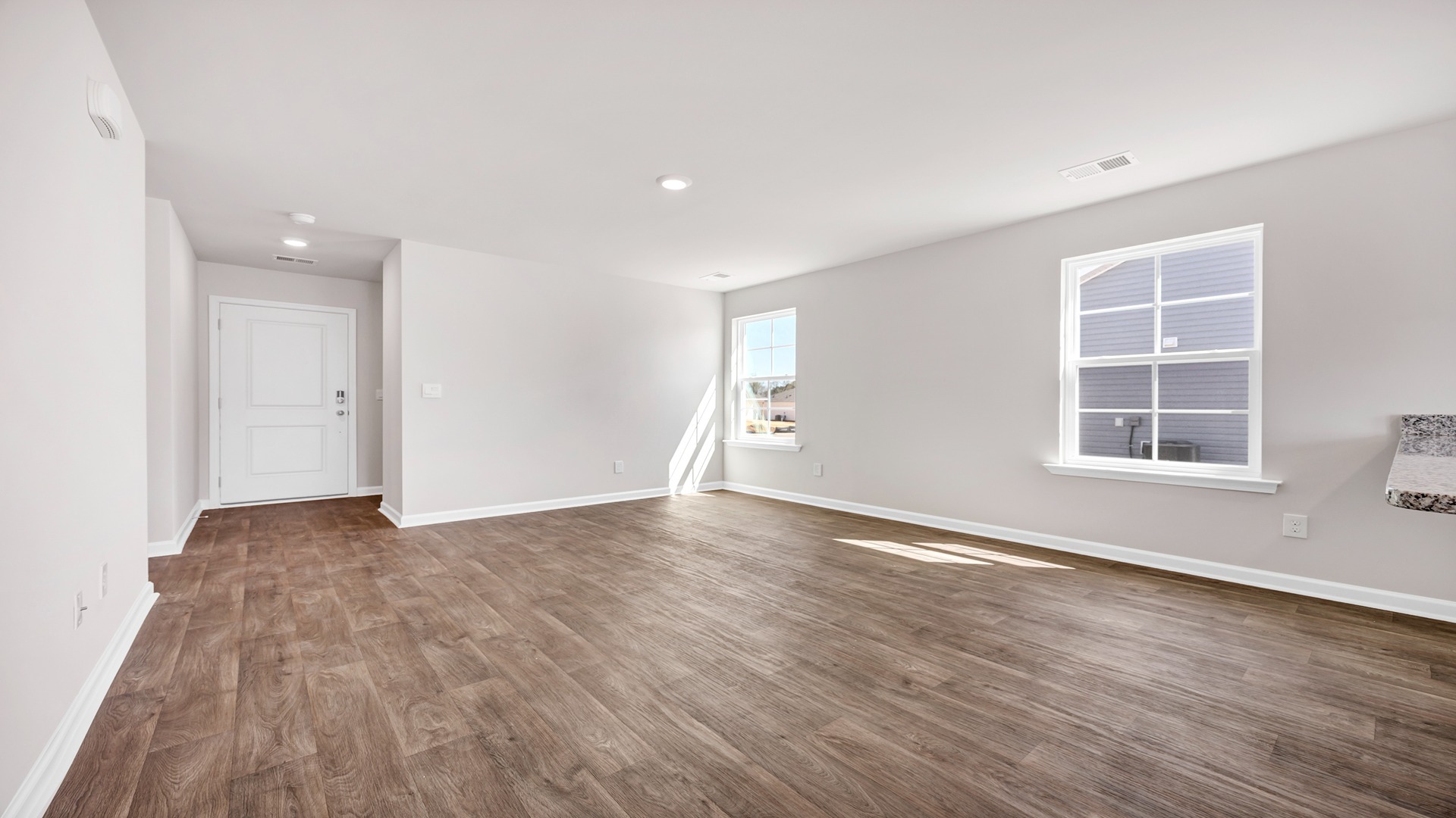 Living area with natural light and vinyl flooring
