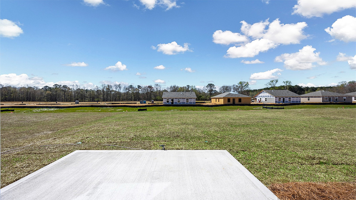 View of spacious backyard from back patio.