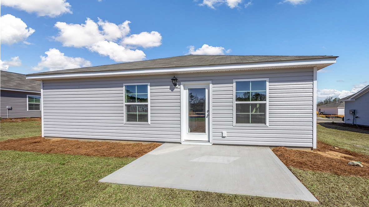 Back exterior of the home featuring a paved back patio.