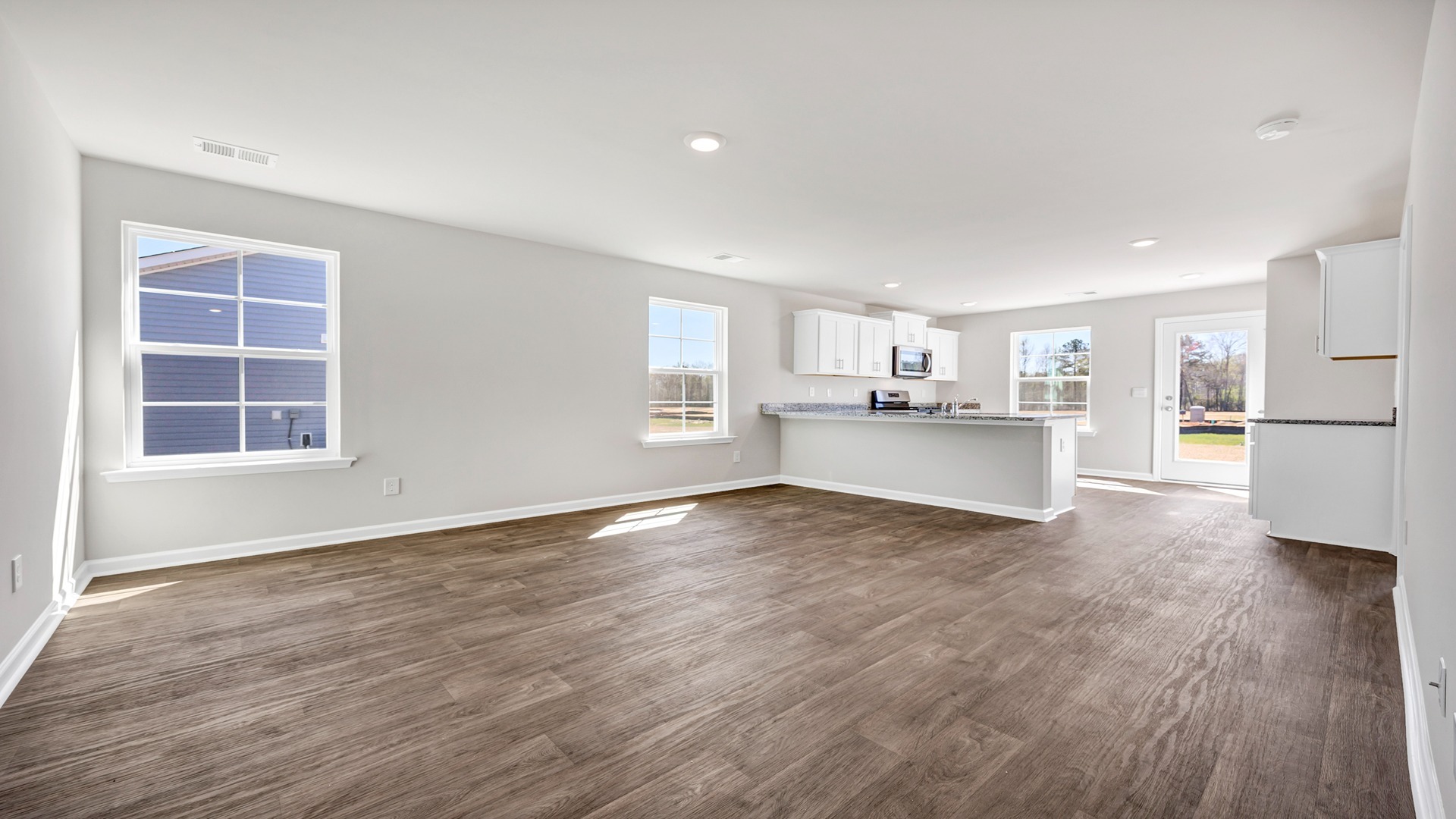 The kitchen and living areas are open concept and finished with vinyl flooring.