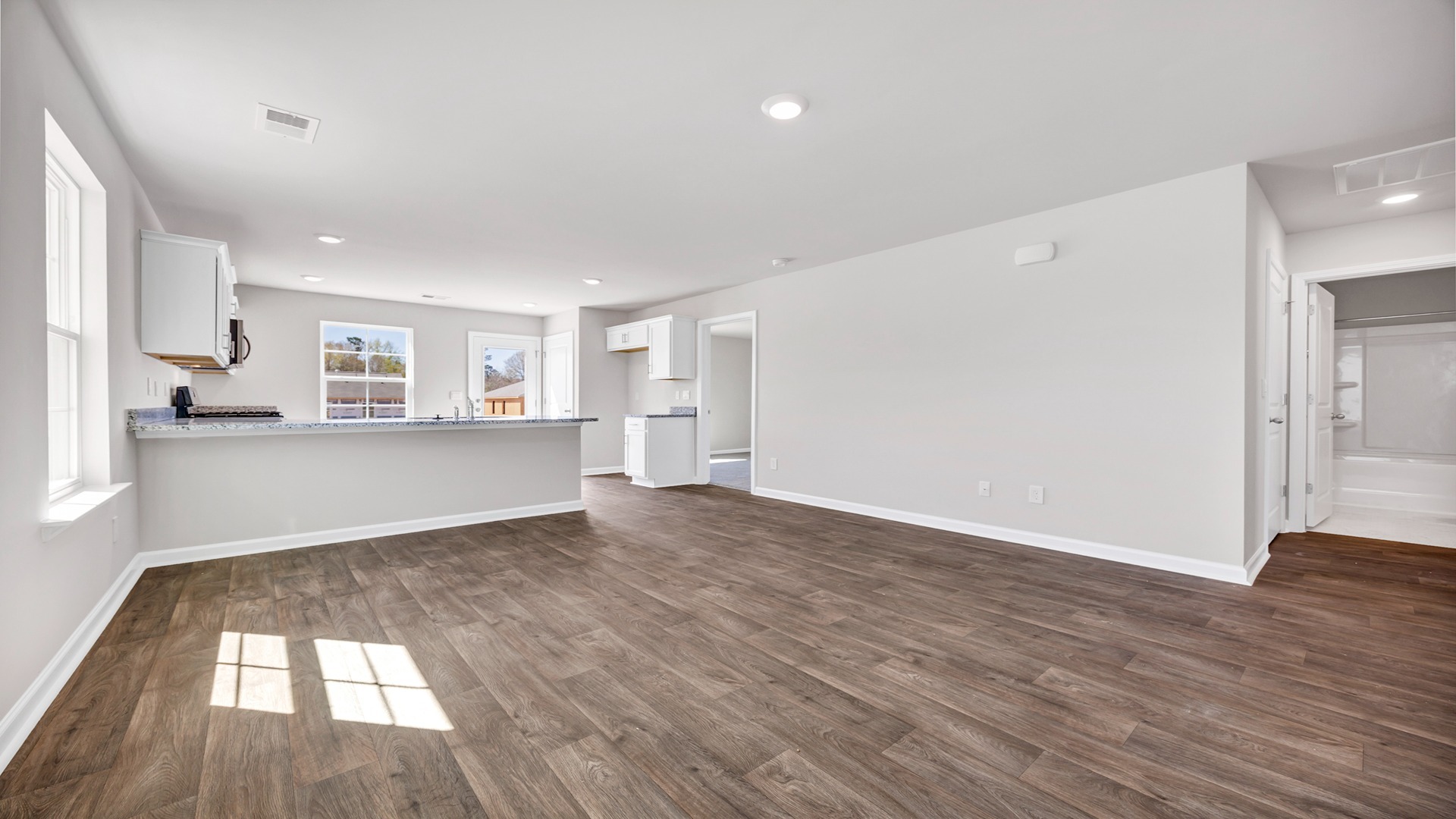 The kitchen and living areas are open concept and finished with vinyl flooring.