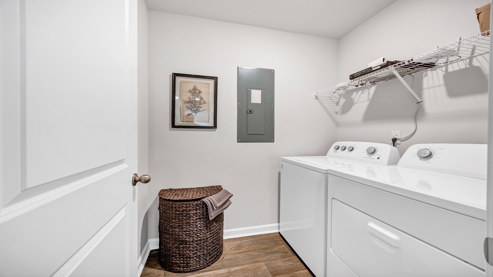 Laundry room at the front of the home with wire shelving above