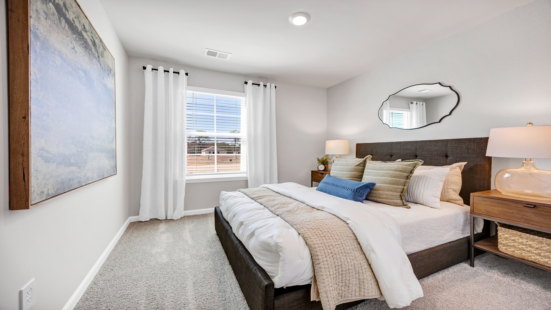 Front bedroom 2 of the one-story home for sale with carpet flooring and window for light