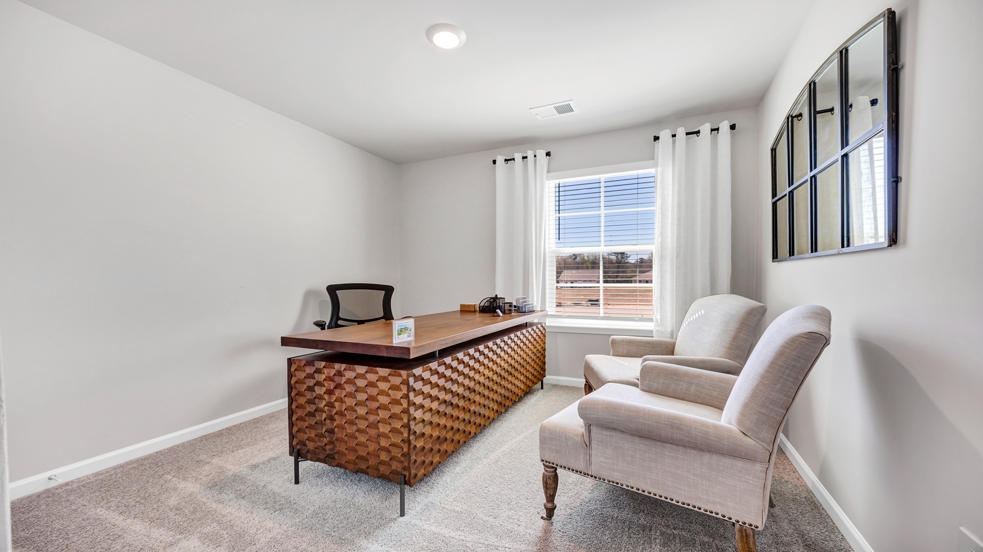Bedroom 3 staged as a home office space with carpet flooring and a window for light