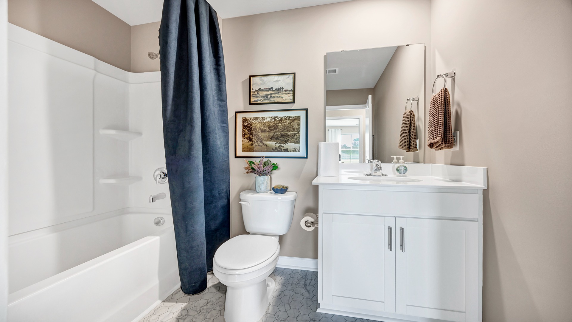 Bathroom 2 at the front of the home with a shower tub combo and single-sink vanity