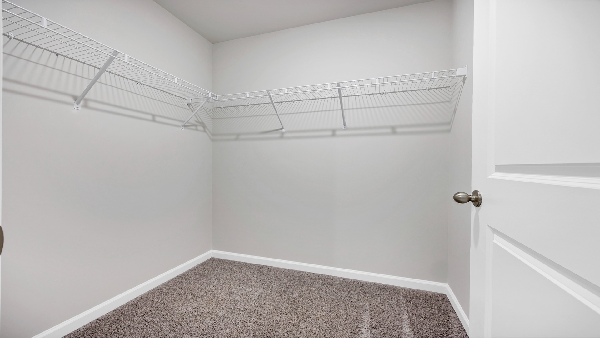 Walk-in primary closet in the primary bathroom of the Curtis floor plan for sale