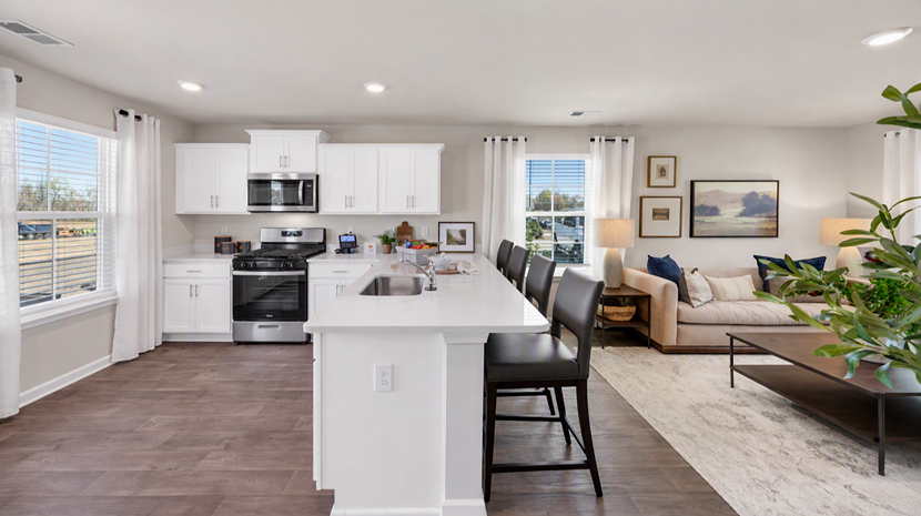 Kitchen space with white quartz countertops and white kitchen cabinets