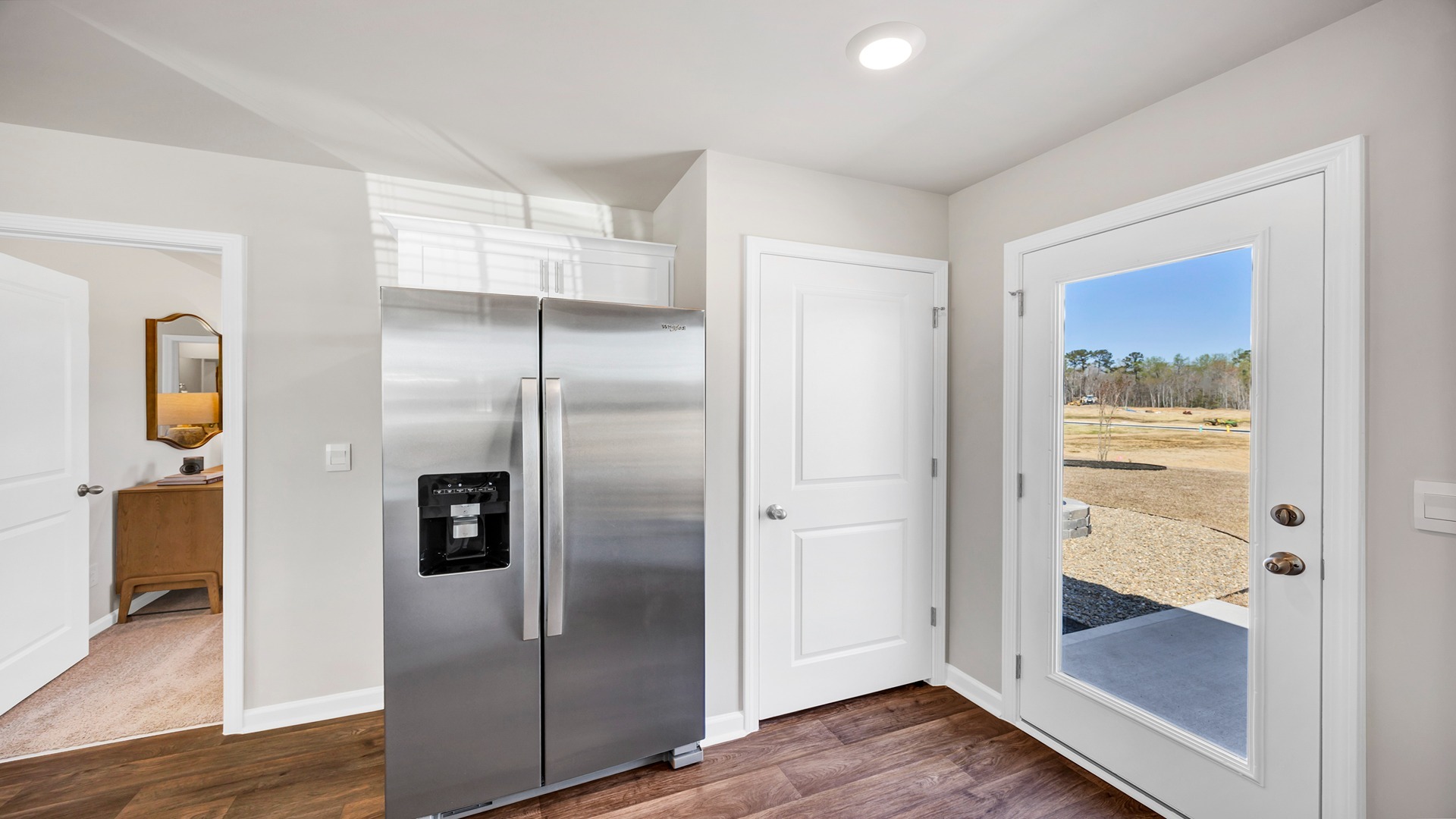 Access to back patio and primary suite off the kitchen space