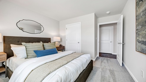 Bedroom two is located beside bedroom 3 and is staged as a guest bedroom.