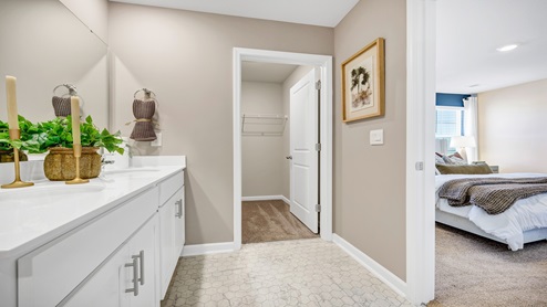 The primary bathroom features double sinks and a walk-in closet.