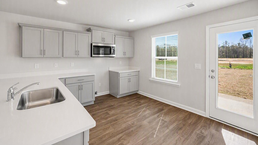 Lewis kitchen with quartz countertops and gray cabinets in new construction kitchen
