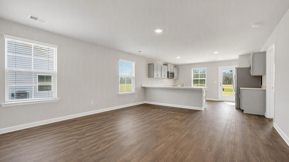 Open living area leads into the kitchen space at the back of the home