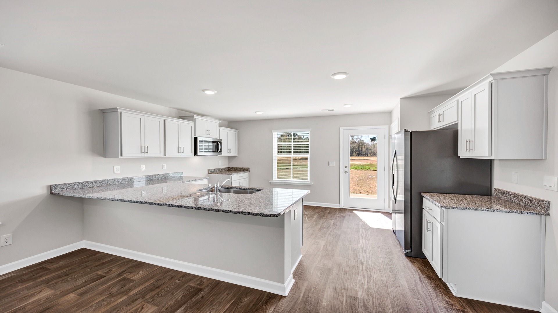 Lewis kitchen with a kitchen bar and white cabinets