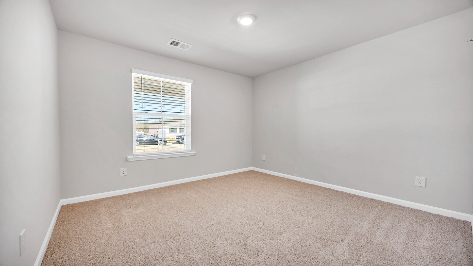 Bedroom 3 with carpet floors and a window for light