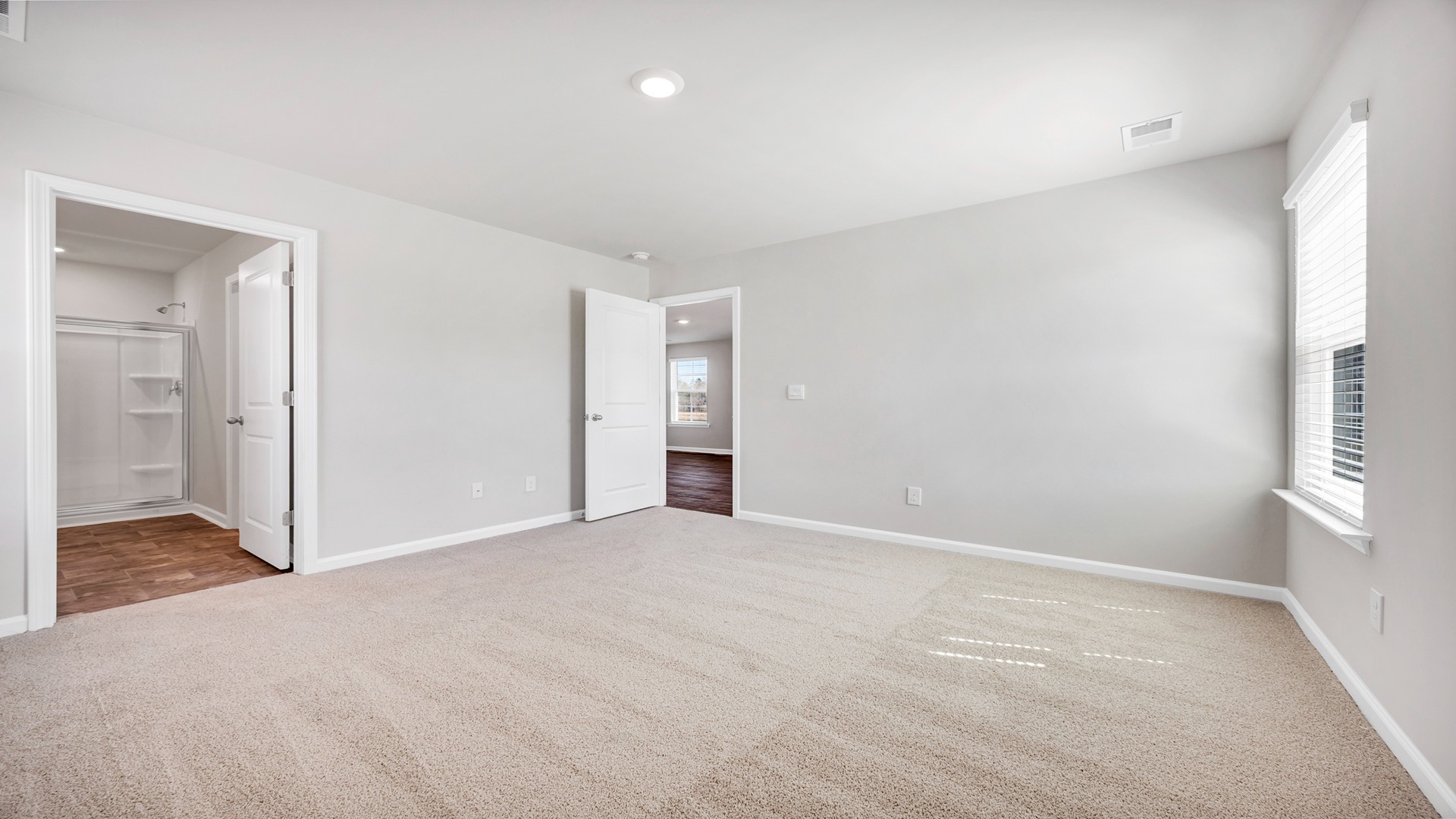 Carpet flooring in the primary bedroom in the Lewis floorplan