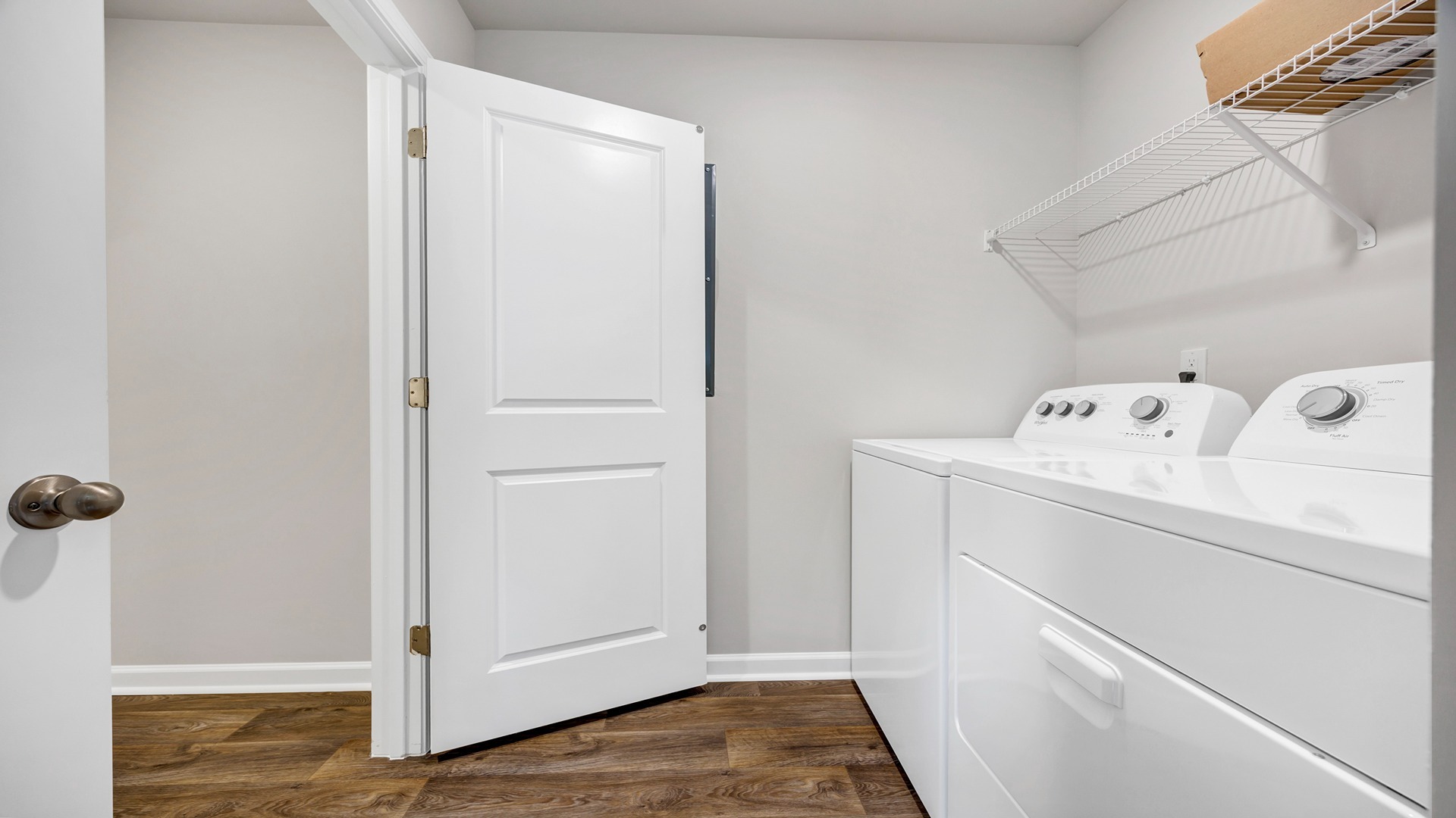 Laundry room with wire shelving above